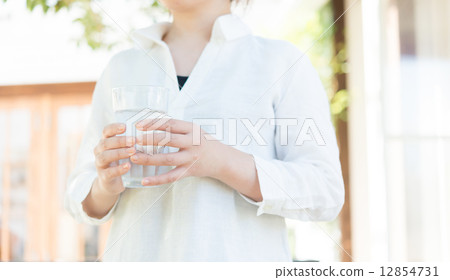 A woman drinking water 12854731