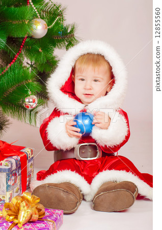 Baby in Santa costume at the Christmas tree with gifts 12855560