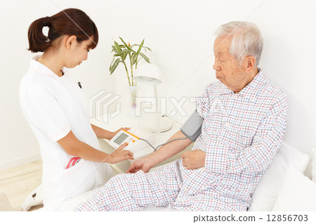 Nurse measuring blood pressure and old man Nurse measuring blood pressure and old man 12856703