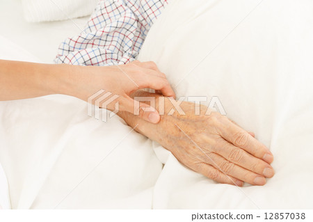 A nurse with a pulse and an old man's hand A nurse with a pulse and an old man's hand 12857038