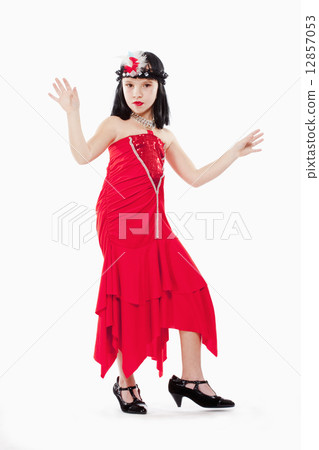 Little Girl in Wig and Red Dress in 1930ties Style 12857053