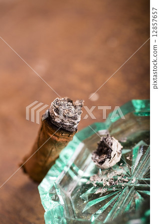 Expensive hand-rolled cigar on a while background 12857657