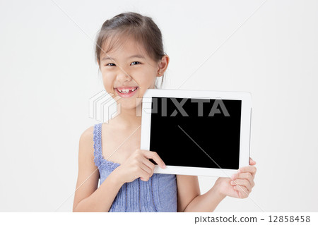 Happy Asian child showing tablet computer 12858458