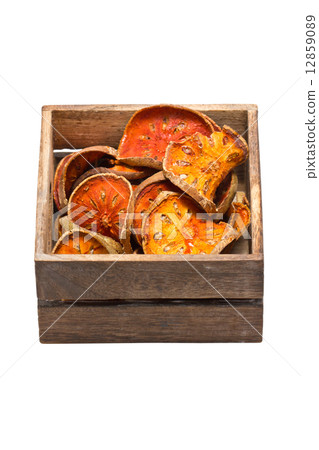 Slices of dried bael fruit with wooden box. 12859089