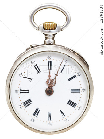 twelve o'clock and five min on dial of retro watch twelve o'clock and five min on dial of retro watch 12861339
