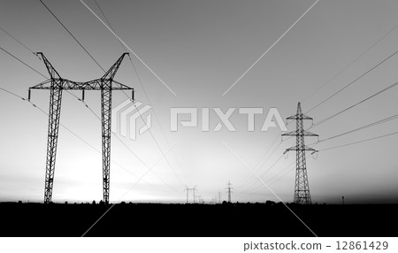 Large transmission towers at sunset Large transmission towers at sunset 12861429