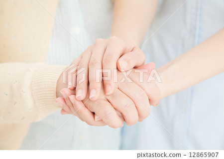 Female nurse holding hands 12865907