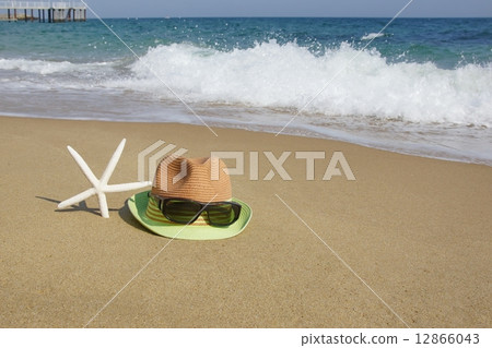 Straw Hat, Sunglasses and  Starfish on the Empty Sea Beach 12866043