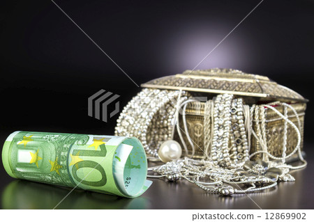 Silver jewelry and Euro on black - Silver jewelry and Euro on black background. Silver jewelry and Euro on black - Silver jewelry and Euro on black background. 12869902
