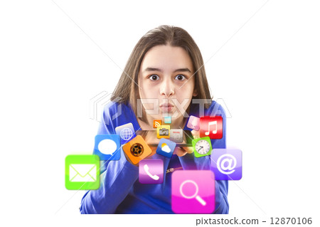 Teenage girl blowing icons from digital tablet Teenage girl blowing icons from digital tablet 12870106