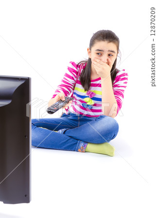 Scared little girl watching tv Scared little girl watching tv 12870209