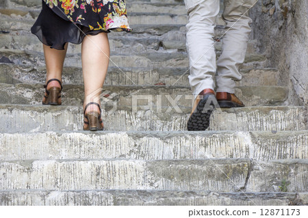 Climbing on stone stairs 12871173