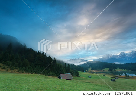 misty sunrise at alpine lake Geroldsee 12871901