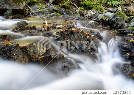 A mountain stream that runs down a rock upstream of the Rakuhoku Kibune River in Kyoto 12873863