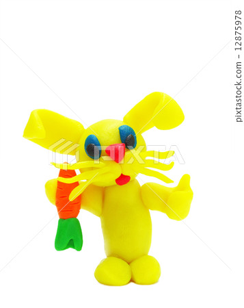 Yellow plasticine rabbit with carrot Yellow plasticine rabbit with carrot 12875978
