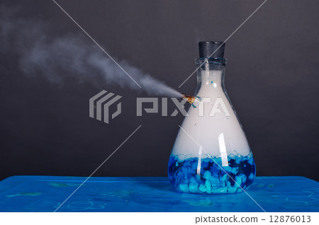 Blue bottle with dry ice soars. 12876013