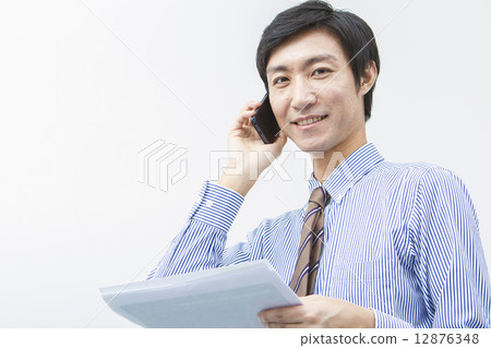Businessman talking on a smartphone Businessman talking on a smartphone 12876348