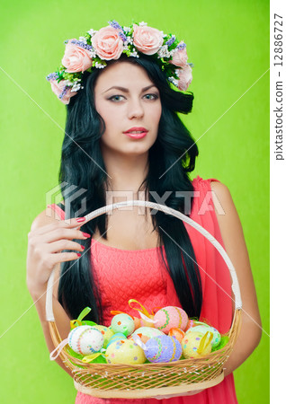 The beautiful girl with a basket of Easter eggs 12886727