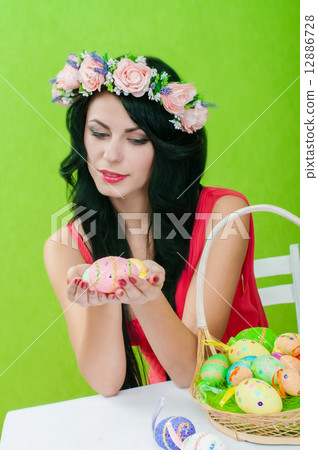 The beautiful girl with a basket of Easter eggs 12886728