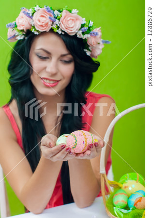 The beautiful girl with a basket of Easter eggs 12886729
