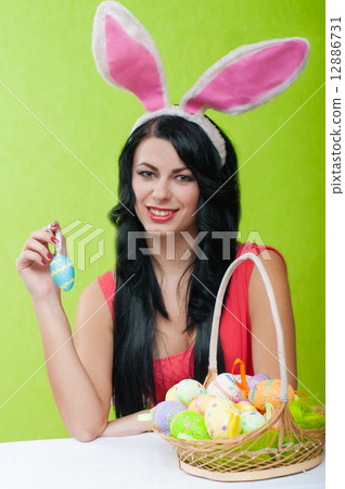 The beautiful girl with a basket of Easter eggs 12886731