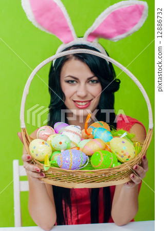The beautiful girl with a basket of Easter eggs 12886732
