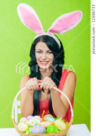 The beautiful girl with a basket of Easter eggs 12886733