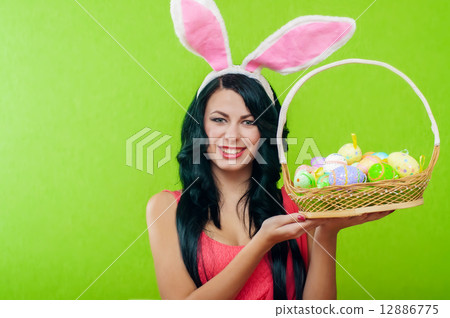 The beautiful girl with a basket of Easter eggs 12886775