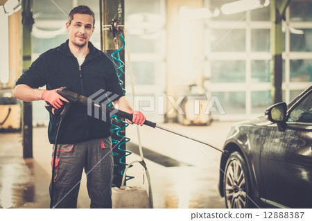 Man worker washing luxury car on a car wash Man worker washing luxury car on a car wash 12888387