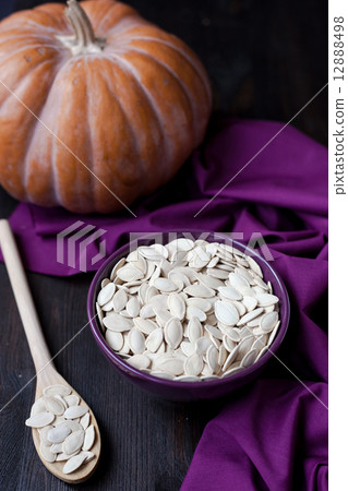 Bowl with toasted pumpkin seeds and pumpkins Bowl with toasted pumpkin seeds and pumpkins 12888498