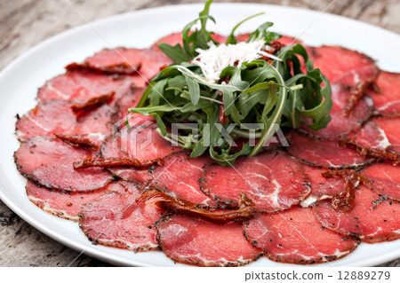 white dish with carpaccio of beef white dish with carpaccio of beef 12889279