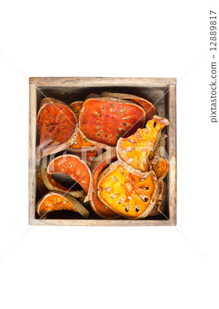 Slices of dried bael fruit with wooden box. 12889817
