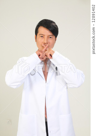 Male medical doctor with hand gestures showing no smoking sign 12891402