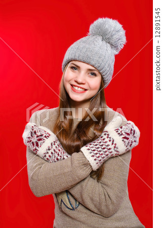 Beautiful girl in a knitted hat and gloves 12891545