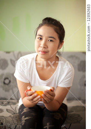 Girl Drinking Tea or Coffee in Cafe 12892683
