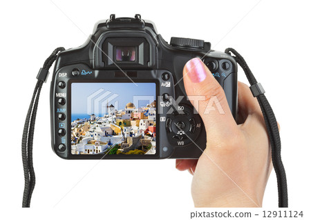 Camera in hand and Santorini (Greece) view 12911124