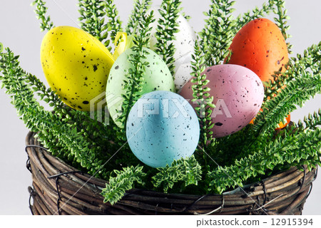 Dyed easter eggs in wicker pot Dyed easter eggs in wicker pot 12915394