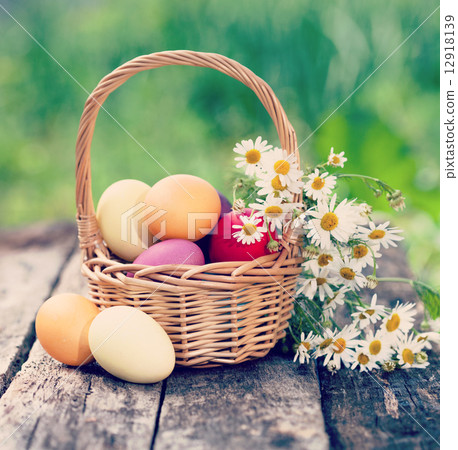 Easter concept - eggs, basket and daisies. Vintage retro hipster Easter concept - eggs, basket and daisies. Vintage retro hipster 12918139