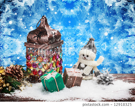 Burning lantern and Christmas decorations in the snow 12918325