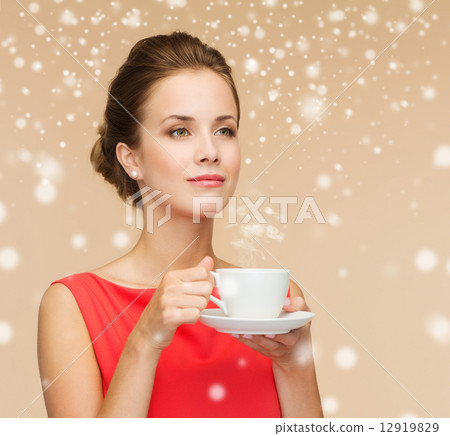 smiling woman in red dress with cup of coffee 12919829
