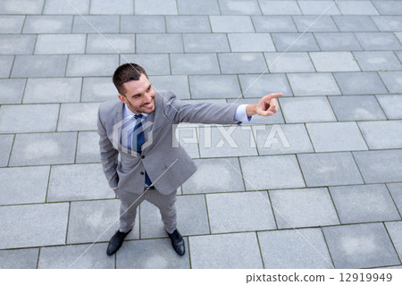 young smiling businessman outdoors from top young smiling businessman outdoors from top 12919949