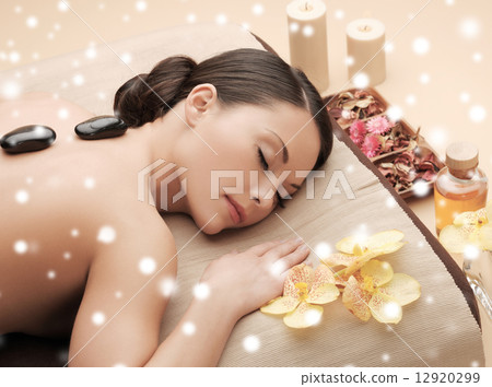 woman in spa salon with hot stones 12920299