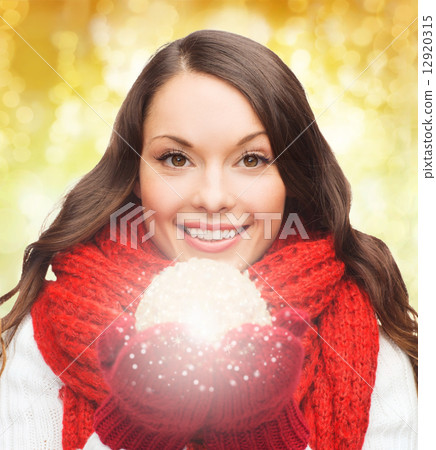 smiling woman in winter clothes with snowball 12920315