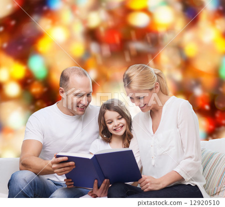 happy family with book at home 12920510