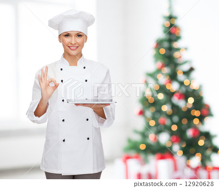 smiling female chef with tablet pc computer 12920628