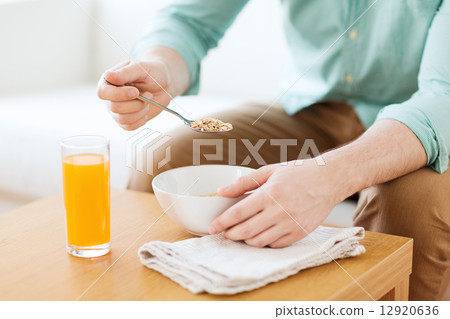 close up of man eating breakfast at home 12920636