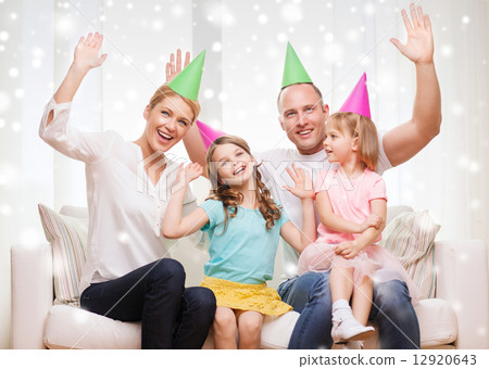 happy family with two kids in party hats at home 12920643