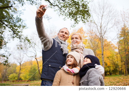 happy family with camera in autumn park 12920666