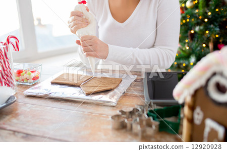 close up of woman making gingerbread houses 12920928