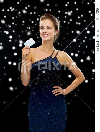 smiling woman in evening dress holding credit card smiling woman in evening dress holding credit card 12920966